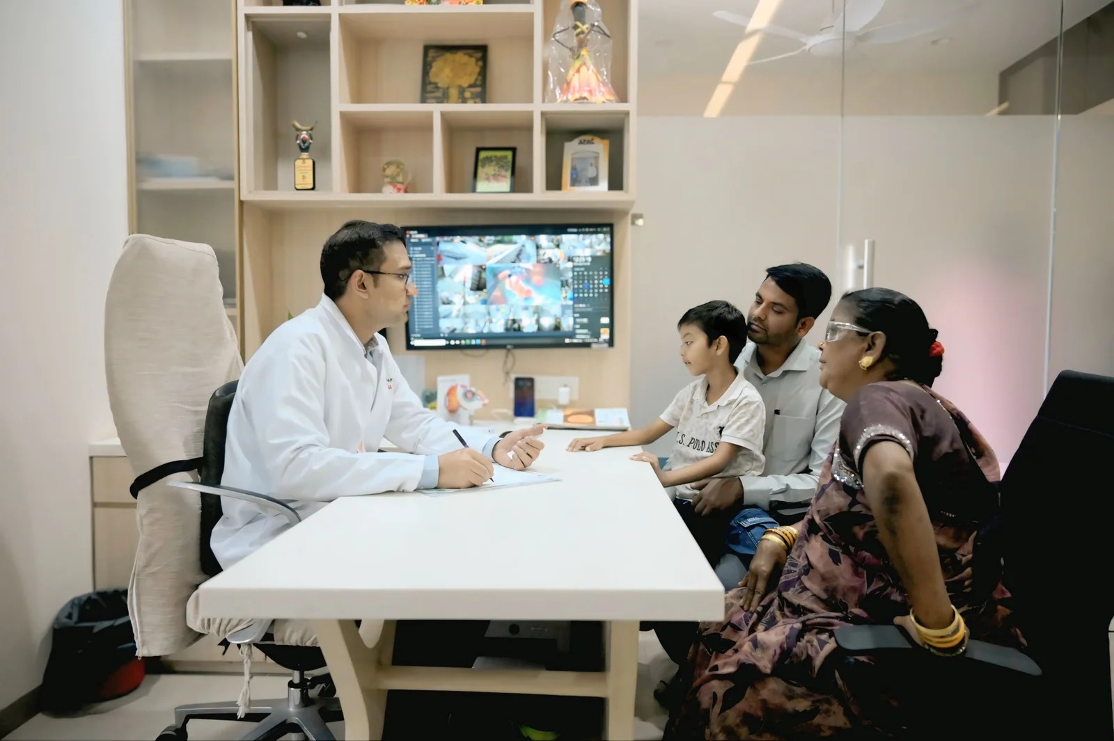 A doctor speaking with a family during an eye-care consultation