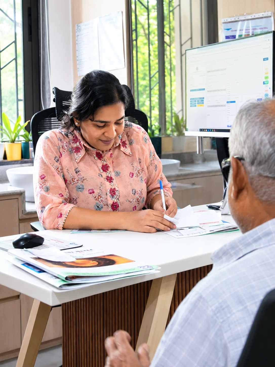 A clinician speaking with a patient during a consultation